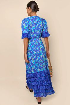 Indulge in the luxurious sophistication of the high-end designer Dress Blue Mari. Handmade with impeccable attention to detail, this long floral dress is perfect for any occasion. From casual shopping trips to elegant banquets, you'll look and feel stunning in the blue floral design. Elevate your wardrobe with this must-have piece. Blue Silk Maxi Dress With Ruffles, Blue Long Dress With Ruffles, Elegant Silk Maxi Floral Dress, Blue Ruffled Maxi Dress For Gala, Elegant Light Blue Maxi Dress With Ruffles, Summer Gala Short Sleeve Maxi Dress, Summer Gala Maxi Dress With Short Sleeves, Short Sleeve Maxi Dress For Summer Gala, Short Sleeve Summer Maxi Dress For Gala