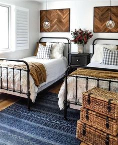 two beds in a bedroom with wooden headboards