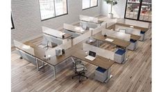 an office cubicle with desks and chairs on the floor in front of windows