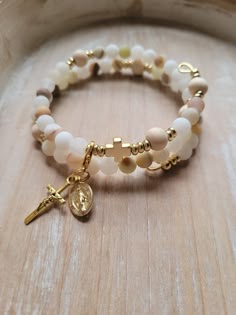 This natural stone, gold plated stainless steel modern Rosary Bracelet is inspired by a beautiful and comforting Bible passage from our Lord Jesus Christ. With the life we live today full of distractions, anxiety, and fears, we need to remember what Jesus said to us through John 14:27.  Jesus says about peace, "Peace I leave with you; my peace I give you. I do not give to you as the world gives. Do not let your hearts be troubled and do not be afraid." Stay in prayer and intercede your prayers t Pearl Rosary Bracelet, Christian Jewellery, Rosary Ideas, Frosted Flower, The Immaculate Heart Of Mary, Flower Jade, Immaculate Heart Of Mary, Christian Bracelets, Heart Of Mary