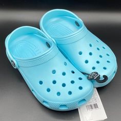 Crocs Classic Clog K Sandals Brand New With Tags Youth Size 3 Color Light Blue Non-slip Round Toe Clogs For The Beach, Light Blue Synthetic Slip-on Slides, Light Blue Synthetic Slides With Round Toe, Blue Slide Sandals For Outdoor, Casual Light Blue Synthetic Flip Flops, Casual Blue Flat Slippers, Casual Light Blue Slip-on Slippers, Blue Flip Flops For Spring Outdoor Activities, Blue Flip Flops For Spring Outdoor