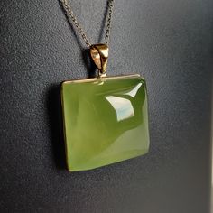 ITEM DESCRIPTION: >>The pendant is made from Solid 14K Yellow Gold. Gemstone used is absolutely natural and ethically sourced. >>Natural Prehnite in Cabochon Square shape with bezel setting is studded on it with utmost precision. >>This is a minimalist design and is absolutely hassle-free and everyday jewelry. Gem: Prehnite Gem size: 23.5x23.5 mm Square Gem weight: 68.8 carats Gold purity: 14K (58.33% approx.) Gold weight: 1.13 grams Gross weight: 14.89 grams The Gold purity is guaranteed and it Elegant Green Gemstones In 14k Gold, Formal Green Onyx Gemstone Jewelry, Green Pendant Gemstones For Formal Occasions, Formal Green Jewelry With High Luster, Formal Green High Luster Jewelry, Green Gemstones Fine Jewelry As Gift, Green Gemstones For Gifts, Fine Jewelry Style, Green Gemstones For Gift In Fine Jewelry Style, Elegant Prehnite Gemstone Jewelry