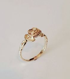 You are looking at a beautiful 14 carat yellow gold rose ring with leaves The ring is all hand carved paying close attention to detail One rose means love at 1st sight Can be ordered in white gold, yellow gold, rose gold, and platinum Can be ordered in sizes 4 to 9 Comes in a beautiful Box Money back guarantee Luxury Gold Flower Promise Ring, Affordable Rose Gold Flower Ring, Vintage Gold Rings Rose, Affordable Rose Gold Flower Ring Gift, Rose Gold Jewellery Rings, Cheap Rose Gold Flower Promise Ring, Cheap Rose Gold Flower Ring As Gift, Cheap Adjustable Rose Gold Flower Ring, Simple Rose Rings