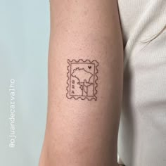 a woman's arm with a stamp on it that has an image of a postage stamp