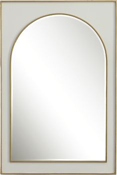 a white and gold framed mirror with an arch shaped design on the front, against a gray wall