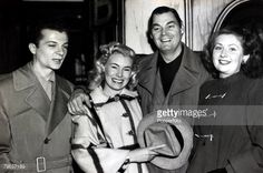 an old black and white photo of three people posing for the camera with one woman holding a hat