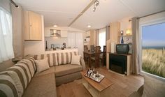 a living room filled with furniture and a flat screen tv mounted to the side of a wall