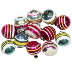 a bunch of ornaments that are on top of each other in different colors and sizes