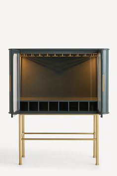 a black and gold cabinet with lights on it's sides, against a white background