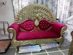 a red and gold couch sitting on top of a tiled floor