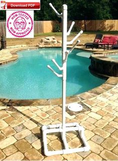 a pool with a white pole and some chairs around it