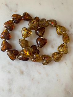 beautiful gemstone heart  bracelet with gold filled beads throughout. 2 colors-  darker brown and light brown runs small, order 1/2 size up for a looser fit Gold Heart Bracelet, Heart Gemstone, Jewel Box, Gold Heart, Heart Bracelet, Heart Of Gold, 2 Colours, Light Brown, Gold Filled