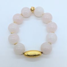 Rose Quartz is known for its calming and loving energy while the gold-plated metal adds an elegant touch. Wear it alone or stack it with other bracelets for a versatile look. Enhance your style with this stunning Rose Quartz and Gold-plated Metal Bead Bracelet. Ro & Gieo Rose Quartz and Gold-plated Metal Bead Bracelet If you want your bracelets in a different size than 7 inches, we are more than happy to accommodate your request. Please simply specify your WRIST SIZE IN INCHES into the ORDER SPE Spiritual Gold Beaded Rose Quartz Bracelets, 8mm Rose Quartz Bead Bracelets, Hand-strung Rose Quartz Bracelet, Metal Bead Bracelet, Hand-strung Rose Quartz Bracelets With Round Beads, Hand-strung Spiritual Rose Quartz Stretch Bracelet, Soft Toothbrush, Brass Bracelet, Copper Bracelet