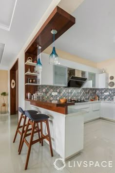 a kitchen with two bar stools next to an island