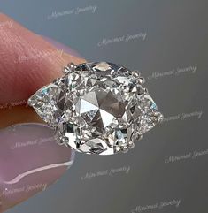 a close up of a person's hand holding a diamond