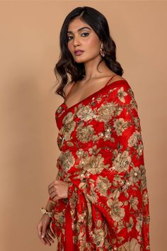 Editor's Note Featuring Varun Bahl's statement floral printed sari highlighted with intricate hand embroidery all over. It is paired with an embroidered corset red blouse. Fabric: Organza Color: Red Component: Sari, blouse and underskirt Sleeve type: Sleeveless Neckline: Sweetheart Fit: Fitted blouse Embroidery details: Hand embroidery Occasion: Festive Blouse length: 14" inches, saree: 5.5 metres, sari width: 45" inches Care: Dry Clean Only About the Designer Varun’s work marries the beauty of Varun Bahl, Cutdana Embroidery, Red Floral Print, Red Saree, Embroidery Floral, Fitted Blouses, Blouse For Women, Embroidery Blouse, Saree With Blouse