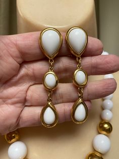 "You must have at least one set of white jewelry just for summer. White pearls don't count. I'm talking fun stuff. Necklace is signed Napier and earrings signed Trifari. Necklace will extend from 16 to 18\" with a hook clasp. Largest front beads are about 18 and 20mm round. They continue to be fairly big at about 10mm near clasp. Earrings are clip backs marked Trifari. Big look at 3\" but the largest section is against the earlobe. Not heavy anyway but I think the largest bead at top is a good i Elegant White Dangle Jewelry, Elegant White Drop Jewelry, Elegant White Clip-on Jewelry, White Pearl Drop Costume Jewelry Necklace, White Drop Earrings For Formal Occasion, Modern White Clip-on Jewelry, White Drop Jewelry For Formal Occasions, Pearl White Clip-on Jewelry, Formal White Drop Jewelry