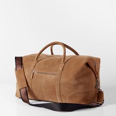 Impeccably crafted from high quality leather or suede, the Graham Leather Collection is filled with classic styles for work and travel. Designed with a place for everything you need for a weekend away, this overnighter features both carrying handles and an adjustable shoulder strap. Add a monogram to for a unique touch.    22"w x 9.75"d x 11"h  Made from leather or suede with a soft cotton lining.  Please see Product Information for more details.  Made in Turkey.  Camel: Monogramming is foil or Elegant Suede Satchel For Travel, Classic Cognac Travel Bag For Everyday, Cognac Leather Weekender Bag For Travel, Classic Leather Travel Bag, Classic Brown Everyday Travel Bag, Classic Travel Bag With Leather Trim For Daily Use, Classic Everyday Duffle Bag With Double Handle, Luxury Leather Camel Satchel, Luxury Camel Leather Satchel