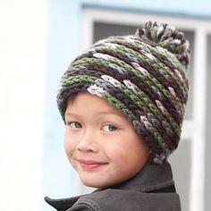 a young boy wearing a knitted hat