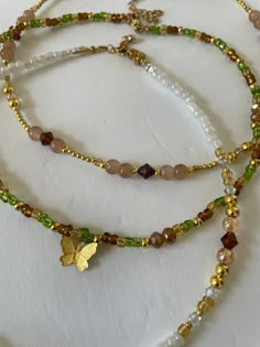 Look beautiful while embracing the spirit of nature with our Forest Fairy Necklaces. A unique blend of hand beaded glass in green, brown and gold, these necklaces are made of glass beads and 14K gold plated beads for lasting wear. Stand tall with nature. Green And Gold Beaded Necklace, Brown Beaded Jewelry, Nature-inspired Brown Beaded Necklaces, Gold Earthy Beaded Bracelets With Round Beads, Handmade Brown Czech Glass Beads, Nature-inspired Beaded Necklaces As Gifts, Nature-inspired Colorful Beaded Necklaces For Gifts, Nature-inspired Colorful Beaded Necklaces As Gift, Brown Czech Glass Beaded Chain Jewelry