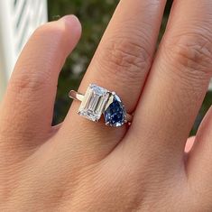 a person's hand with a ring on it and an engagement ring in the middle