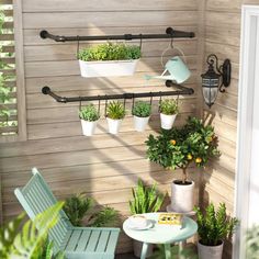 an outdoor patio with potted plants on the wall and two chairs next to it