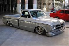 a silver pickup truck parked in front of a building