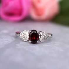 Presenting You A Beautiful Cluster Garnet Ring that you can Stack along with other Ring or go the way you like Combo. The Garnet is Eye Clean Accented along with Cubic Zircon to add more sparkle. Perfect For Proposal Wedding Gift or Anniversary Present or Being Garnet Jan birthstone you can gift it on Birthday too. The Lustre Refraction Along with Rich Red  Color of the Gem is definitely the query maker. Item No: skj. 07.513 Item: Natural Garnet In 925 Silver (Can Be personalized) Primary stone: Natural garnet  Secondary Stone: Cubic Zircon Article Weight:2.5 gms primary stone Size:7x5 mm Ring Length:2cm Ring Width:0.7  cm Maintenance Tips 1. Keep the jewelry away from direct heat, water, perfumes, deodorants, and other strong chemicals.  2. Wipe the Jewellery gently with a chamois cloth o Oval Silver Ruby Promise Ring, Sterling Silver Oval Promise Ring, Oval Sterling Silver Stackable Rings, Oval Sterling Silver Stackable Rings Fine Jewelry, Oval Gemstone Stackable Rings For Promise, Oval Gemstone Stackable Promise Rings, Sterling Silver Oval Birthstone Promise Ring, Oval Stackable Promise Rings With Accent Stones, Oval Sterling Silver Promise Ring