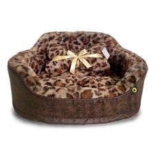 the leopard print dog bed has a gold bow on it's head and is brown