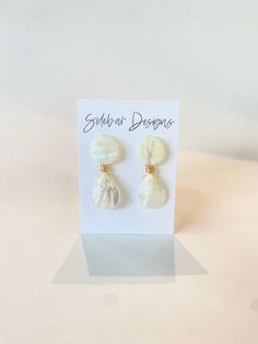 These mother of pearl earrings are handmade. Very elegant while making such a statement. They are great for every day wear, bridal earrings, bridesmaid earrings, and more.  Dimensions: approx. 2" Hypoallergenic gold plated & light weight If you purchase 6 or more, use discount code Bridesmaids15 for 15% off! Mother Of Pearl Single Drop Earring, White Pearl Charm Earrings For Party, Party Pearl Drop Earrings In Mother Of Pearl, Wedding Earrings With Pearl Charm And Mother Of Pearl, Wedding Mother Of Pearl Earrings With Pearl Charm, Clip-on Drop Wrap Earrings As Gift, Pearl Drop Mother Of Pearl Earrings, White Pearl Clip-on Earrings, Elegant Cream Earrings For Gift