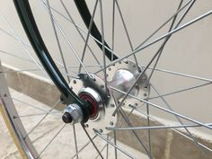 the front wheel of a bicycle with spokes and hubs is seen in this image