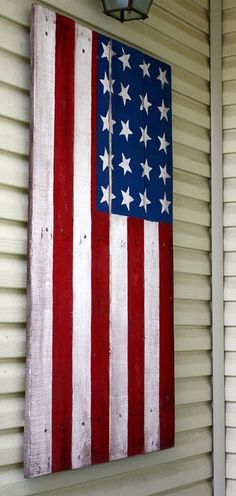 an american flag painted on the side of a house in red, white and blue