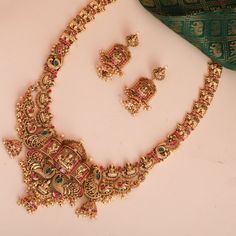 Description : As vibrant as India's diverse culture, comes this antique finish gold plated silver long necklace. Paksha's master craftsmen have used the traditional Nakshi style to craft this heirloom necklace set. It is beautiful combination of Goddess Lakshmi and peacock motifs. This intricately crafted necklace is embellished with kempu and CZ stones. The antique finish add timeless look to the design. Style this with short nakshi necklace for a grand look. Product Information : Materials use Oxidized Temple Jewelry Necklace As Gift, Gift Temple Necklace With Oxidized Finish, Oxidized Kundan Temple Jewelry Necklace For Ceremonial, Fusion Style Temple Necklace With Cutdana For Gift, Heavy Fusion Necklace For Puja, Kundan Temple Jewelry Necklace As Gift, Kundan Temple Necklace As A Gift, Multicolor Oxidized Temple Necklace For Wedding, Temple Style Oxidized Necklace For Festivals