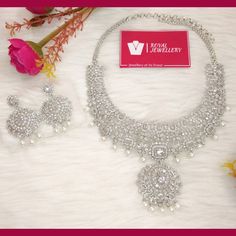 Beautiful American diamond heavy bridal necklace with earrings. Diamond set replica. High quality. Perfect for any occasion. More variety on our shop. Feel free to contact us for any enquiries. Please provide detailed address with contact number when order is placed as it is required on shipping label. Dazzling Silver Jewelry Sets For Festive Season, Traditional Diamond Chandbali Jewelry Sets, Reception Jewelry Sets With Intricate American Diamond Design, Traditional Chandbali Diamond Jewelry Sets, Festive Diamond Jewelry Set With Intricate Design, Festive Diamond Jewelry Sets With Stone Work, Bollywood Style Silver Cubic Zirconia Jewelry Sets, Traditional Bridal Sets With Intricate Design And American Diamond, Silver Kundan Necklace With Elegant Cubic Zirconia Design