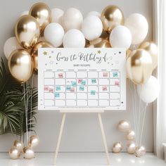 a baby shower calendar surrounded by gold and white balloons