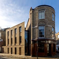 an old brick building on the corner of a street