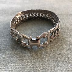 "This bracelet has some weight to it. The curb chain at the center is flanked by snake chains which are soldered to it so the piece moves as a sinuous whole. The clasp belies the more modernist look of the chain, with it's lyre shaped finials holding the fold over closure. The piece measure 7 3/4\" long by 3/4\" wide.  I'm happy to ship internationally but costs have risen so dramatically I can no longer ship worldwide for $12. If you are outside of the US and want to make a purchase. Let me kno Metal Cuban Link Bracelet With Curb Chain, Cuban Link Bracelet With Curb Chain In Metal, Adjustable Metal Jewelry With Curb Chain, Adjustable Metal Curb Chain Jewelry, Sterling Silver Jubilee Link Bracelet, Metal Link Jubilee Bracelet, Metal Jubilee Link Bracelet, Silver Metal Cuff Bracelet With Chain Detail, Metal Box Chain Link Bracelets