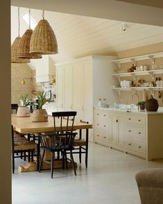 an open kitchen and dining room with white walls