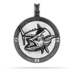 a black and white photo of a fish on a silver medal with the words, s