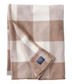 the brown and white checkered blanket is folded up