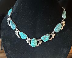 Sterling older Natural gorgeous large Turquoise Statement Necklace (I believe it is a unique studio made Mexican creation) that works with Southwestern , Mexican, contemporary jewelers and with gorgeous bright color.  Each baroque natural Turquoise is bezel set with stylized sterling links between the stones.  I've not seen another like it; what a  vision to see it worn.  Condition I see no problems, nice decorated box clasp, quality made-photos show the details.  Length approx. 20", center is approx. 1 1/4" wide, wt.- approx. 100 grams.  This is a Stunning artist hand wrought vintage Treasure. Artisan Turquoise Necklace, Collectible Turquoise Necklace With Natural Stones, Untreated Bohemian Turquoise Necklace For Collectors, Turquoise Statement Necklace, Large Necklace, Box Clasp, Make Photo, Wedding Jewellery Necklace, Wedding Necklaces