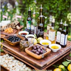 an outdoor picnic with food and wine on the table in front of it that says food