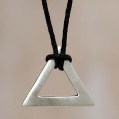 Handsome modern designed necklac for men. Jose Antonio Ibeibarriaga transforms a perfect triangle of sterling silver into a captivating pendant. Crafted with a brushed satin finish, the pendant is worn on black cotton for a masculine necklace of minimalist artistry. Sterling silver & cotton Fold-over clasp Brushed-satin finish 21.75" (55.25 cm) Handmade in & fairly traded from Peru Mens Accessories Necklace, Black Hills Gold Jewelry, Mens Sterling Silver Necklace, Mens Necklace Pendant, Triangle Necklace, Black Hills Gold, Silver Jewelry Necklace, Mens Pendant, Sterling Silver Mens