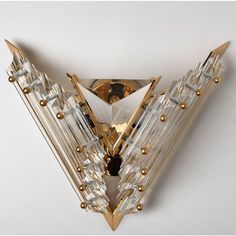 a gold and clear brooch with spikes on it