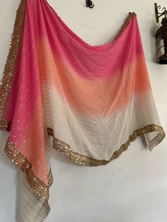 Georgette sheer dupatta. Ombre color pink orange dupatta with golden border This Dupatta is georgette with beautiful golden border and all over mukashi work. This can be your wedding dress chunni for Indian occasion wear for festival. This has perfect bling for you to look classy and ethnic at same time.  This can be made in any color.  More Indian dupatta here in our collection https://www.etsy.com/shop/neelcreations/?section_id=15880219 NOTE : There might be slight color variation due to diffe Luxury Pink Dupatta For Ceremonial Occasions, Dyed Dupatta Designs, Luxury Sheer Katan Silk Dupatta, Ombre Outfits Indian, Traditional Drape Orange Sharara With Sheer Dupatta, Pink Chinon Sharara With Cutdana Detail, Orange Sharara With Dupatta In Traditional Drape, Pink Georgette Salwar Kameez With Cutdana, Pink Dupatta With Cutdana For Party