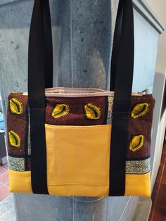 Stitched with attention to detail, this bag is made of two fabrics. The corn-yellow lower side is made of imitation leather, therefore very stable, the brown-coloured fabric is made of cotton and has been reinforced with fleece. On the front is a pocket, which can be closed with a Velcro. The lining is beige with a small pattern, also made of cotton fabric.  At the top is a beiger zipper sewn in. The straps are completely sewn around the bag and not only give the bag a great design but also make Brown On-the-go Shoulder Bag With Pockets, Brown School Shoulder Canvas Bag, Brown Rectangular Canvas School Bag, Yellow Satchel Bag For On-the-go, Brown Satchel Canvas Bag For School, Brown Canvas Shoulder Bag For Daily Use, Brown Cotton Bags With Leather Handles, Brown Pouch Shoulder Bag With Pockets, Fabric Backpack For Daily Use