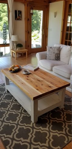 a living room filled with furniture and a wooden table