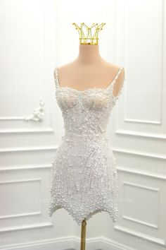 a white dress on a mannequin with a crown on it's head