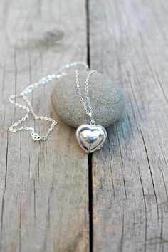 925 sterling silver Puff Heart Locket on a delicate, shimmering silver chain. Insert your own photos or keepsakes. Please select length from the drop down menu. C O M P O N E N T S: Chain - 925 sterling silver (including rings and clasp) Locket - 925 sterling silver, 17.2x18.5mm, double sided with hinge Your item will arrive in a pretty embossed jewelry box - Ready for gift Giving! Dainty Silver Necklace For Anniversary Gift, Sterling Silver Keepsake Charm Necklace, Personalized Sterling Silver Locket Necklace For Mom, Sterling Silver Charm Necklace For Keepsake, Elegant Silver Locket Necklace As Gift For Mom, Sterling Silver Keepsake Locket Necklace, Sterling Silver Locket Necklace For Keepsake, Sterling Silver Keepsake Locket Necklace With Round Pendant, Handmade Silver Locket Necklace For Valentine's Day