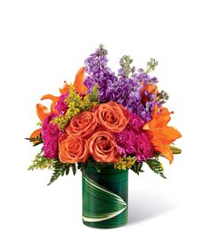 a green vase filled with orange and purple flowers